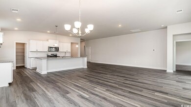 Kitchen with white cabinets, a kitchen island with
