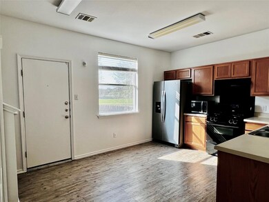 Kitchen with visible vents, light wood-style floo