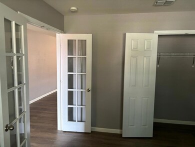 Unfurnished bedroom featuring a closet, french doo