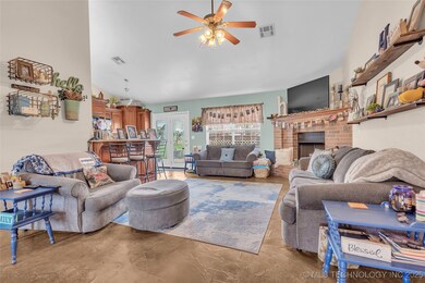 Living area with ceiling fan, concrete flooring, a