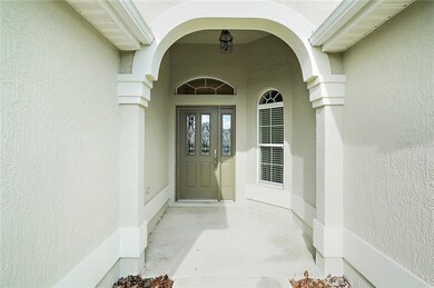 Covered front entrance with elegant leaded glass d