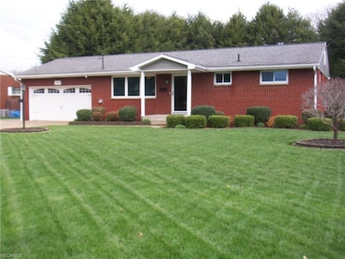 All brick home featuring new garage door and opene