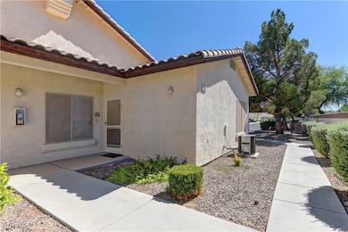 View of exterior entry with stucco siding and a tile roof