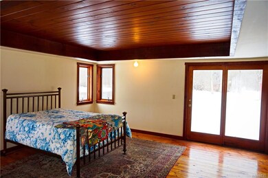 Master bed room with stepped wood ceiling and pati