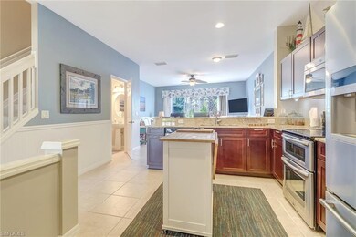 Long view of kitchen, family room, 1/2 bath & stai