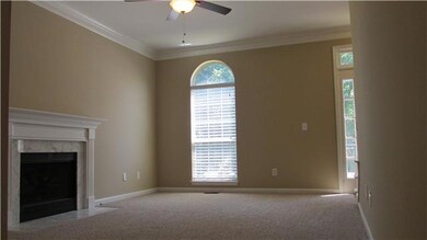 Spacious Living Room with new carpet, gas fireplace, new ceiling fan, etc.