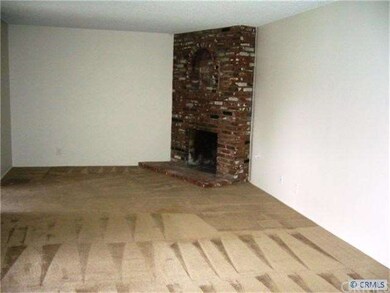 Great brick fireplace in an open living room which
