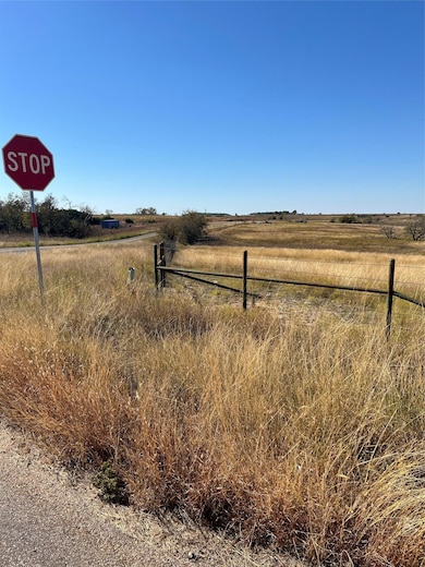 View of street featuring traffic signs and a view of countryside