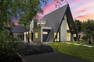 View of front of property with asphalt driveway, 