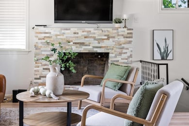 Living area with a fireplace and wood finished fl