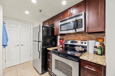 This charming kitchen features warm, rich cabinets