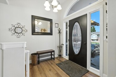 Entrance foyer with a chandelier and wood finished floors