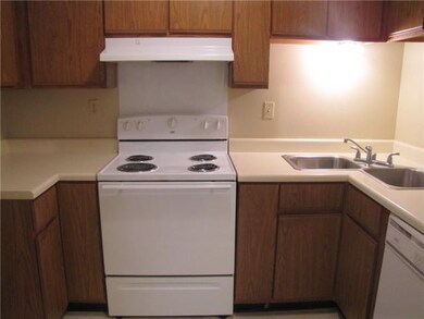 Features a range/oven with ventahood, double sinks