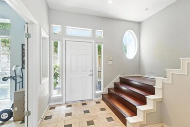 Entrance foyer featuring stairway and baseboards