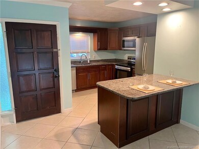 Kitchen with stainless, granite and counter seatin