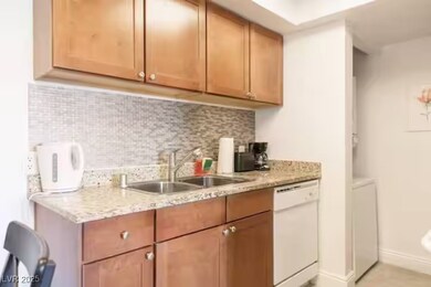 Kitchen featuring dishwasher, a sink, and decorati