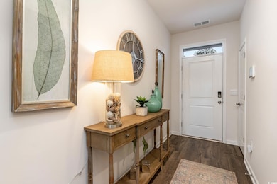 Doorway to outside featuring dark wood-type floori
