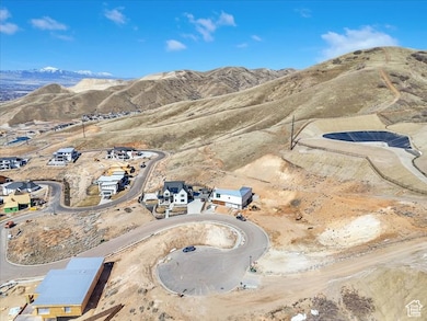 Aerial view of property and surrounding area featuring mountains