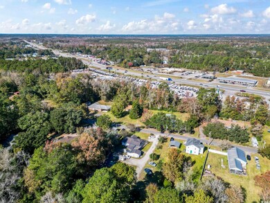 View of property location featuring a tree filled landscape