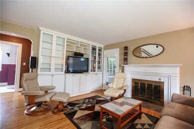 Spacious living room has hardwood floors, a workin