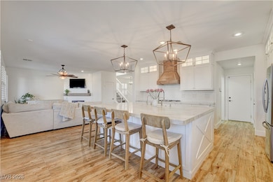 Kitchen with white cabinets, light wood-style floo