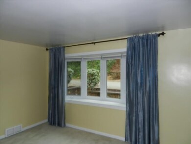 Spacious living room with newer bow window.
