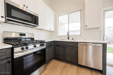 Kitchen featuring white cabinets, light wood-style