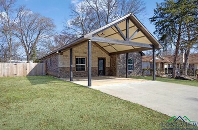 Rear view of property with an attached carport, br