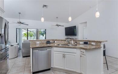 Kitchen with open floor plan, a ceiling fan, appli