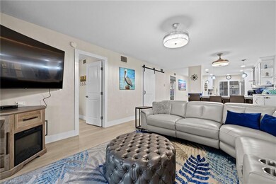 Living room featuring a barn door and light hardwo