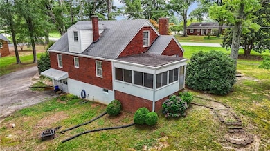 Aerial view with sunporch on the end of home.
