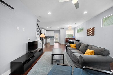Living area with dark wood-style flooring, a ceil