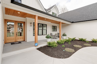 The wide, welcoming front walk leads to a beautiful double-door entry and a spacious front porch.  What a great place to enjoy a chat with any guests who may drop by unexpectedly!