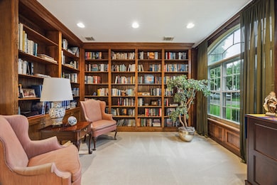 To the right of the entryway is an INCREDIBLE LIBRARY with built-in shelves for all who LOVE books! This room is truly a respite.