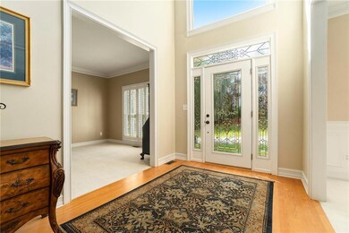 Foyer entrance featuring wood finished floors and 