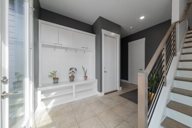 Mudroom with light tile patterned floors