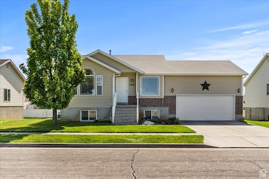 View of front of house featuring concrete driveway, brick siding, and roof with shingles