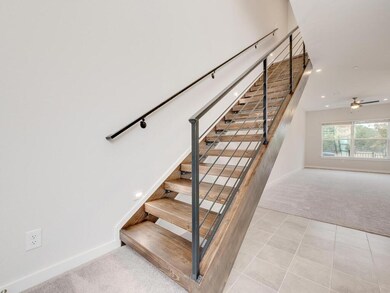 Stairway featuring ceiling fan, recessed lighting