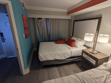 Bedroom with crown molding and hardwood / wood-sty