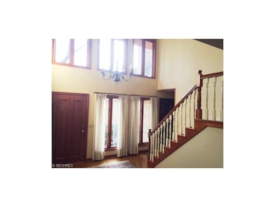 Elegant two story foyer entry with open staircase
