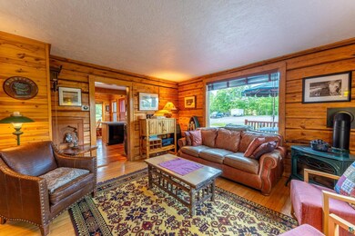 Living room featuring wood walls, light hardwood /