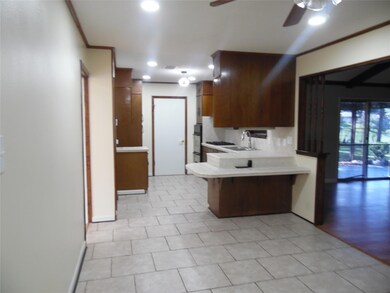Kitchen with sink, a kitchen bar, ceiling fan, kit