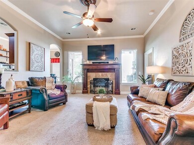 Living room featuring ornamental molding, carpet f