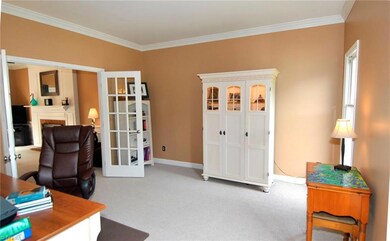 Living Room with French doors, opens to Den