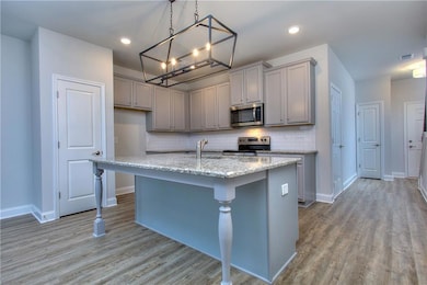 Kitchen with a center island with sink, appliances