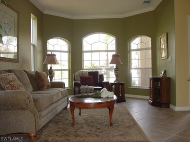 Formal living room off large foyer with crown mold