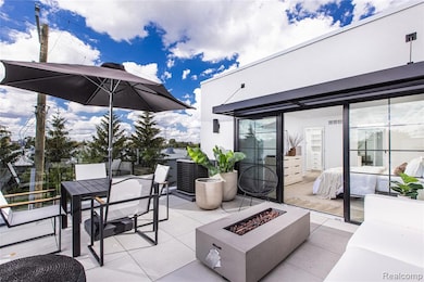 View of patio featuring outdoor dining area and an outdoor fire pit