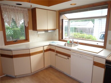 The huge boxed window brightens the Kitchen work s