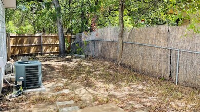 Fenced backyard featuring cooling unit