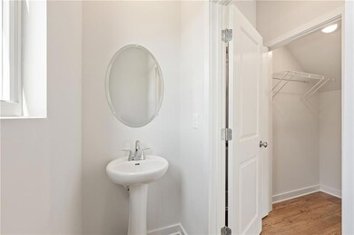 Bathroom with wood finished floors and baseboards